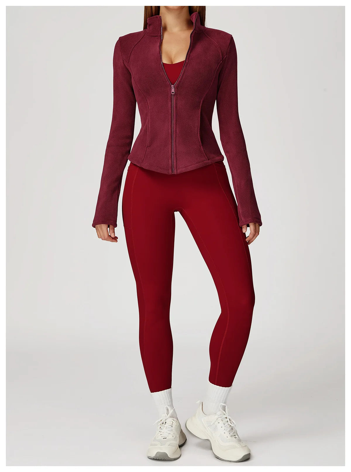 Person wearing a maroon jacket and leggings set 