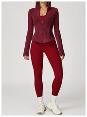 Person wearing a maroon jacket and leggings set 