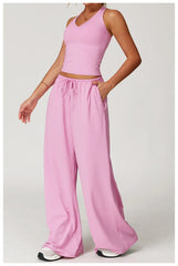 Person wearing a pink sleeveless top and wide-leg pants