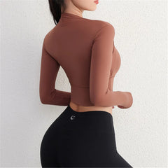 Person wearing a brown long-sleeve top and black pants- back