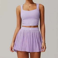 Person wearing a matching lavender top and pleated skirt on a plain background