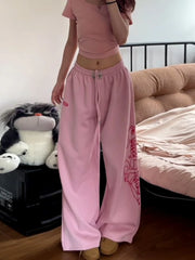 Person wearing pink outfit with tiger design in a bedroom setting
