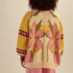 Person wearing a colorful floral-patterned cardigan