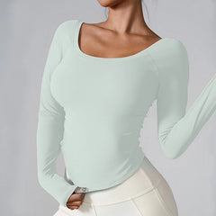 Mint green long-sleeve top worn by a person on a plain background