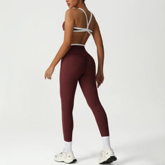Person wearing maroon leggings and a white sports bra - side view