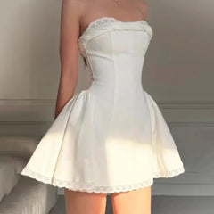 Women's elegant white strapless mini dress with a fitted bodice and A-line skirt.

