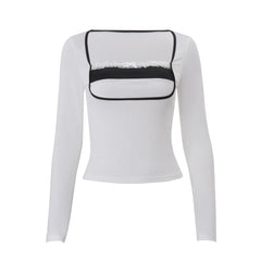 White long-sleeve top with black lace detailing 