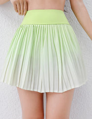 Green pleated skirt worn by a person -close-up