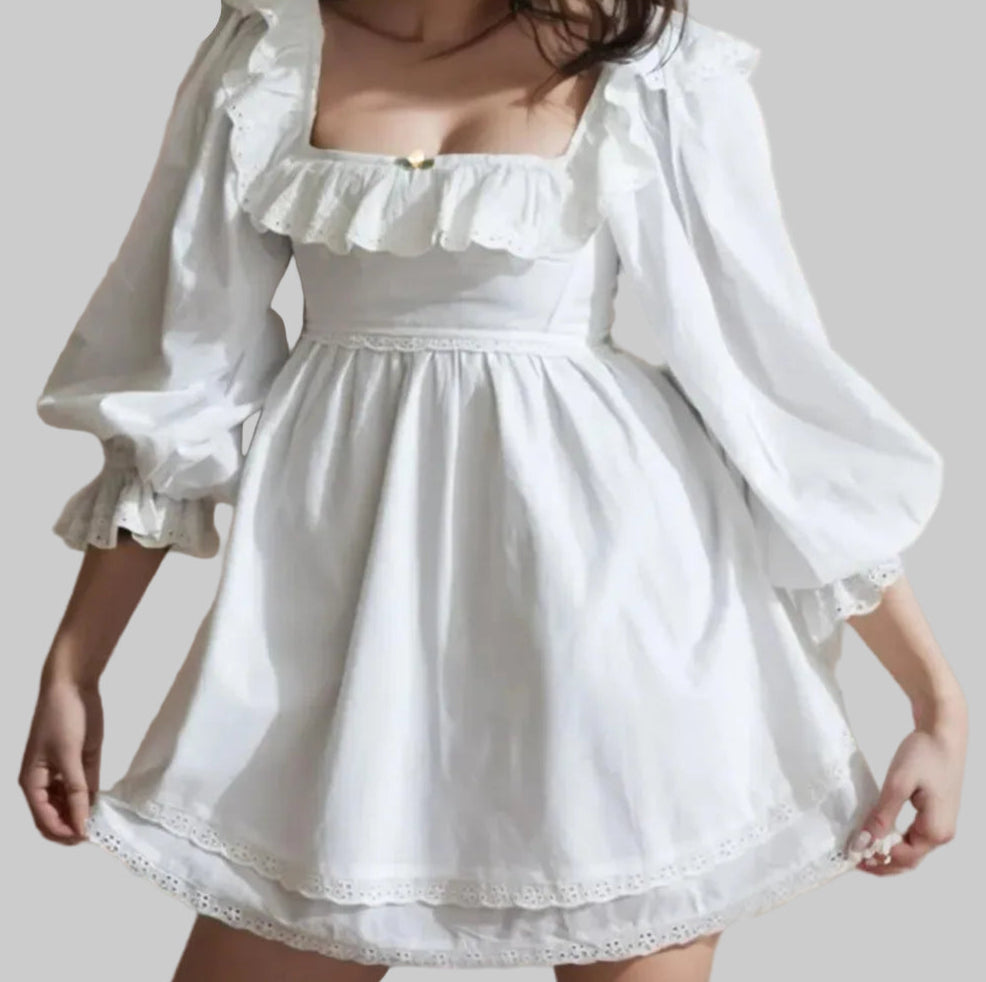 White dress with ruffled sleeves and neckline 