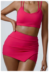 Person wearing a bright pink sports bra and skirt set-front