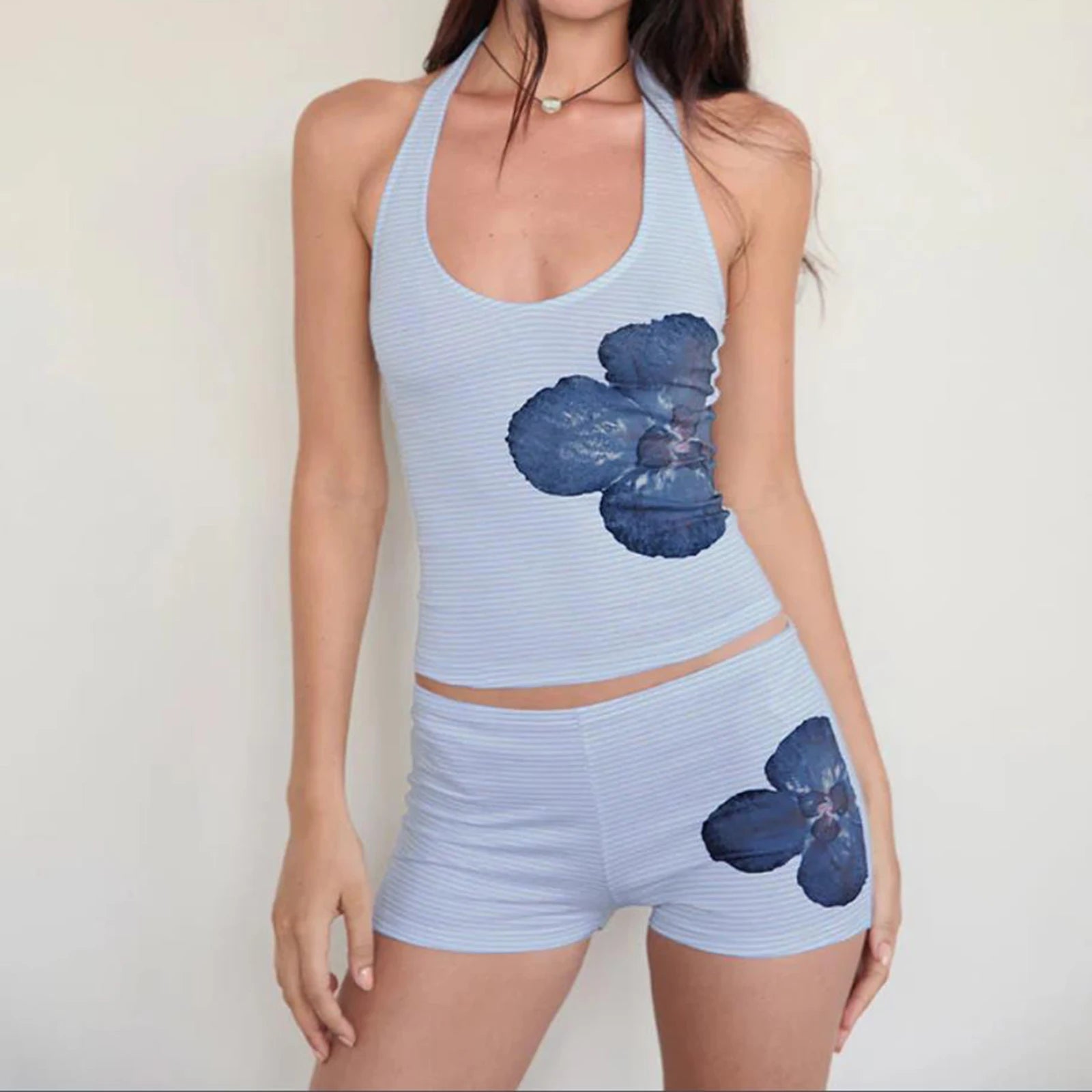 Light blue athletic outfit with floral designs on a plain background