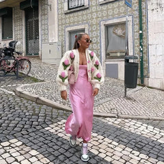 A woman wearing a 3D embroidered cardigan, highlighting how it adds a pop of personality to her outfit.