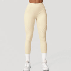 Beige leggings worn by a person on a gray background