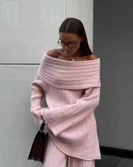 A woman wearing a cozy off-shoulder top , showcasing its versatility and comfortable style.