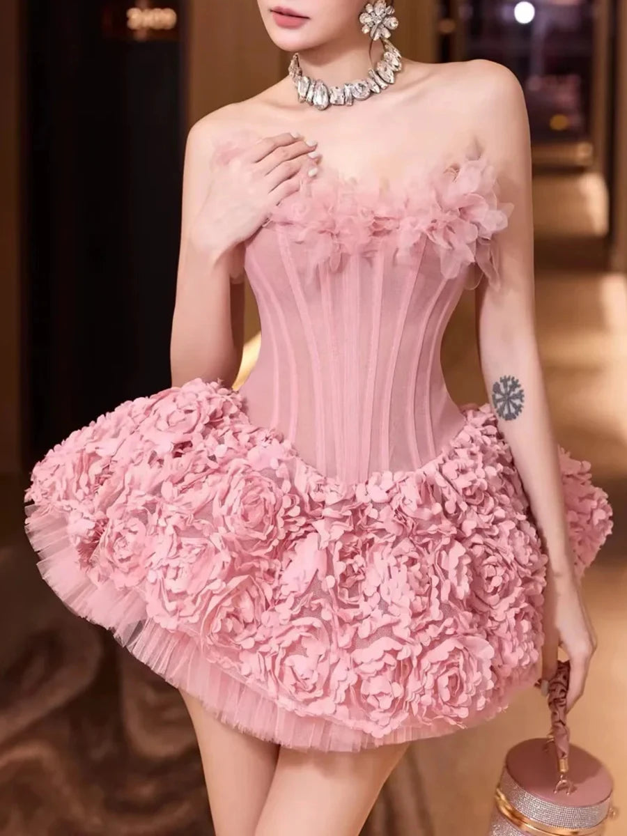 Woman wearing a pink floral dress with a blurred background