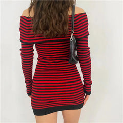 Back view of a woman wearing a red and black striped off-shoulder long-sleeve mini dress with a black handbag.