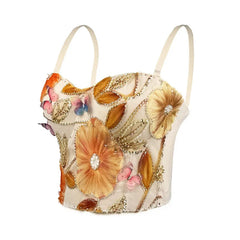 Decorative top with floral patterns and embellishments on a white background