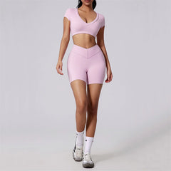 Person wearing a pink athletic outfit on a plain background