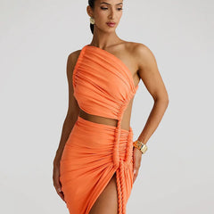 A one shoulder midi dress featuring cut out, rope detailing, and a slit, shown on model.