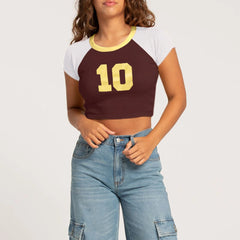 Person wearing a crop top with number 10 and jeans 