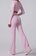 Person wearing a pink long-sleeve top and flared pants