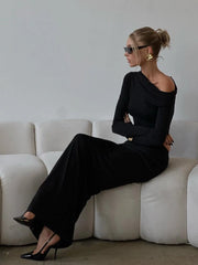 A woman wearing a black off-shoulder top and maxi skirt set, showcasing the flattering silhouette and elegant style, perfect for a special occasion.