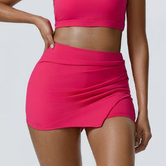 Person wearing a bright pink skirt and top 