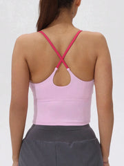 Person wearing a pink sports bra with criss-cross straps- back