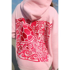 Pink hoodie with red turtle design on the back against a blue sky.