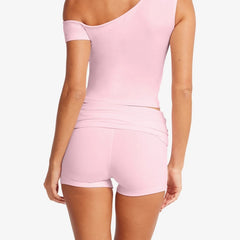 Women's light pink solid crop top and matching shorts set with off-shoulder top and ruched details.

