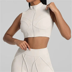White sleeveless top with zipper detail worn by a person on a light gray background
