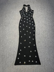 Black dress with white floral patterns on a gray background
