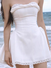 Women's elegant white strapless mini dress with a fitted bodice and A-line skirt.

