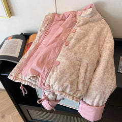 Floral-patterned jacket with pink trim on a surface