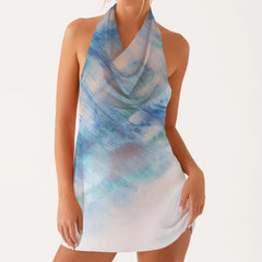 Woman wearing a sleeveless dress with blue and white abstract pattern 
