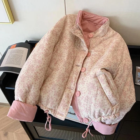 Floral-patterned jacket with pink trim on a surface