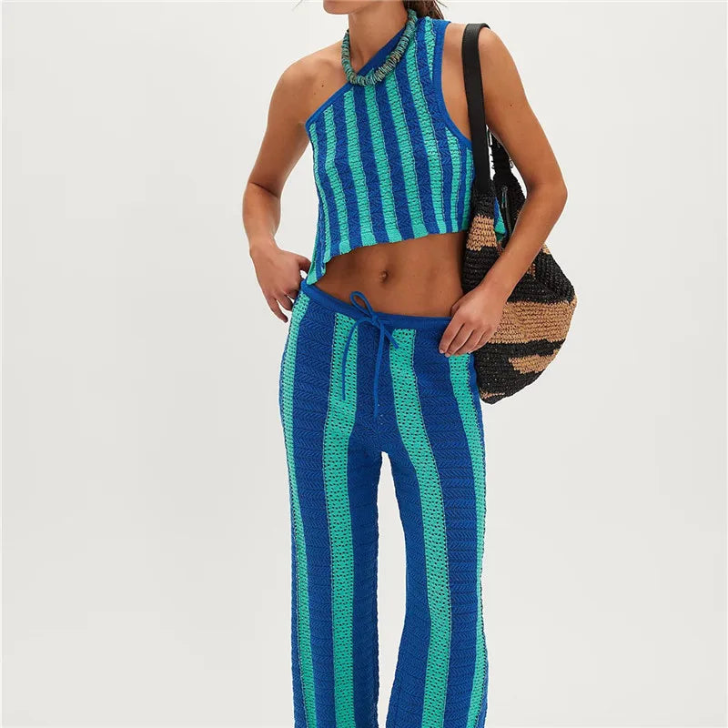Person wearing a blue and green striped outfit with a black bag on a white background