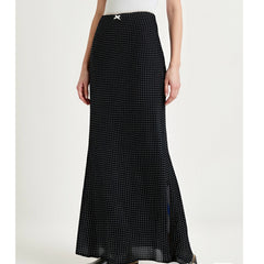 Black polka dot skirt worn by a person