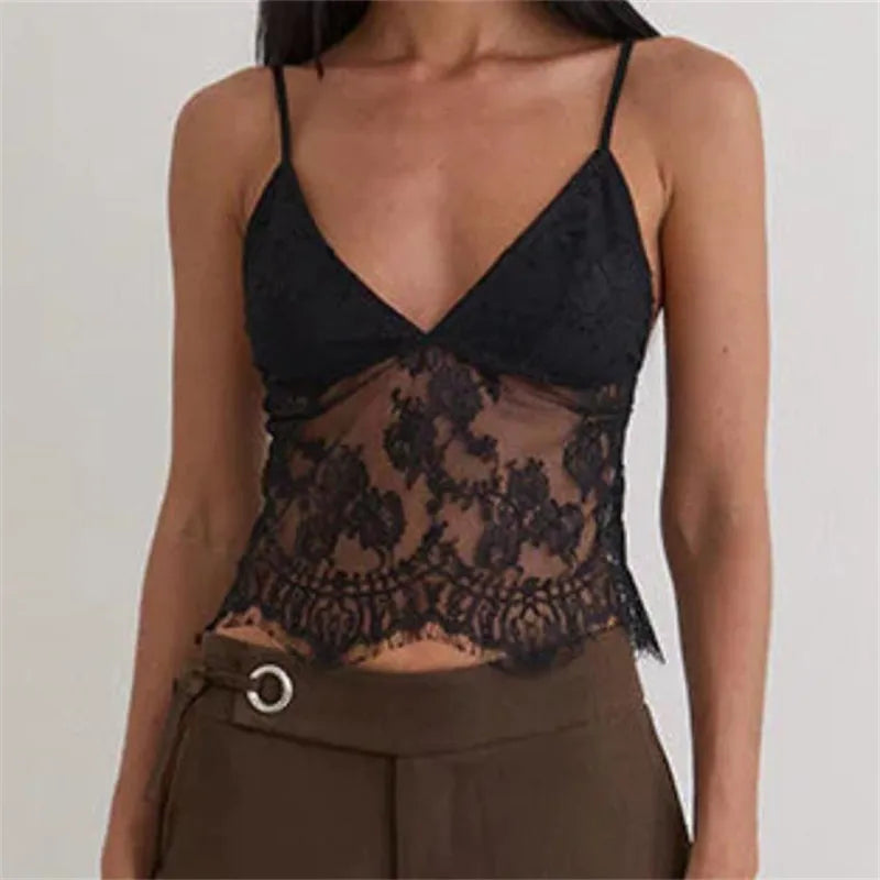 Black lace top worn by a person on a plain background