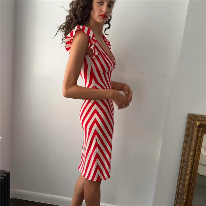 Close-up of the V-neckline and flutter sleeve detail on a red and white chevron striped midi dress.
