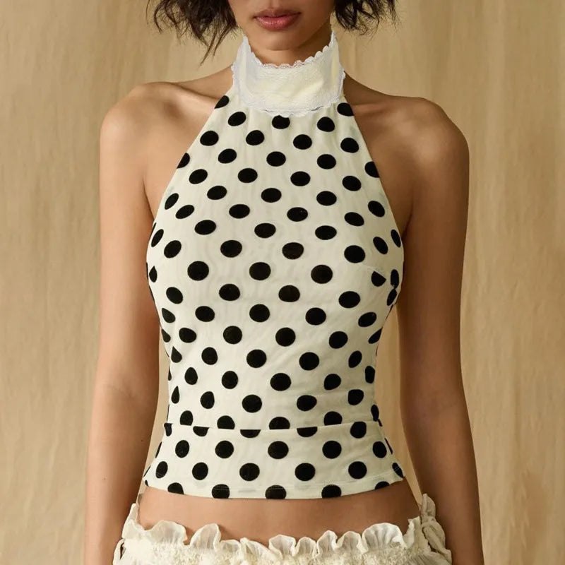 Polka dot halter top with white lace trim on a neutral background