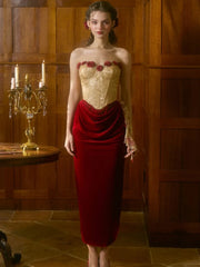 Woman wearing a gold top and red skirt in a wooden room.