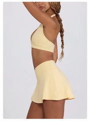 Yellow two-piece swimsuit worn by a model - side view
