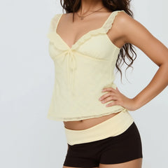 Woman wearing a light yellow top and black shorts