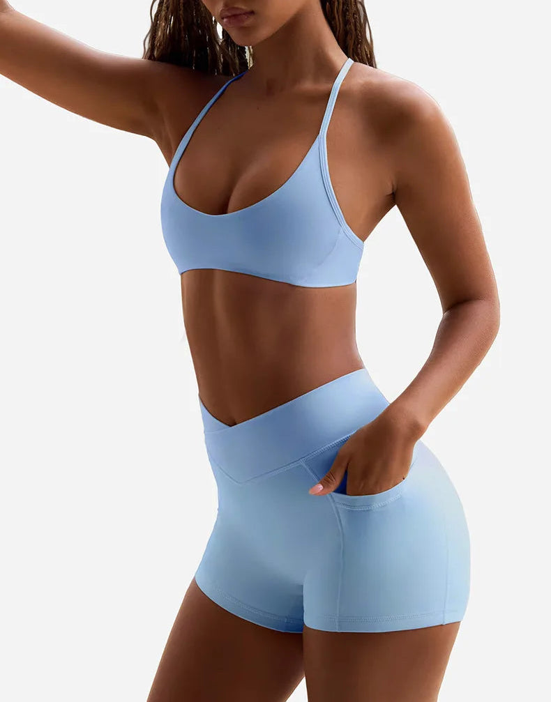 Woman wearing a light blue sports bra and shorts set front view