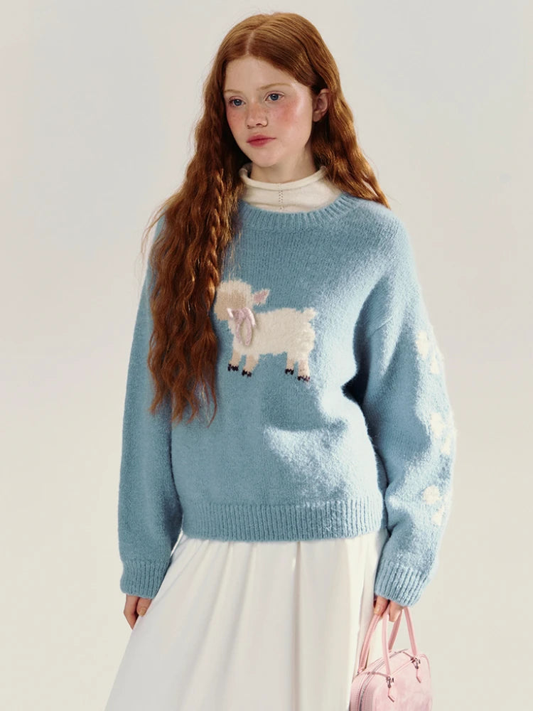 Person wearing a blue sweater with a sheep design 