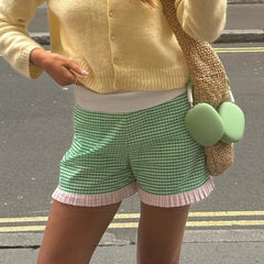 Women's charming green plaid shorts with ruffled hem.

