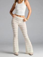Person wearing textured white pants and a white top 