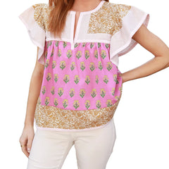 Woman wearing a colorful top with floral patterns