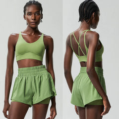 Woman wearing a green sports bra and shorts set from front and back views 